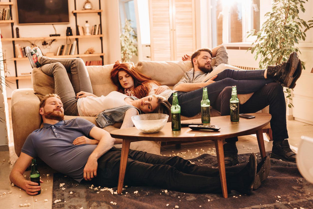 Young drunk people resting with eyes closed at home.